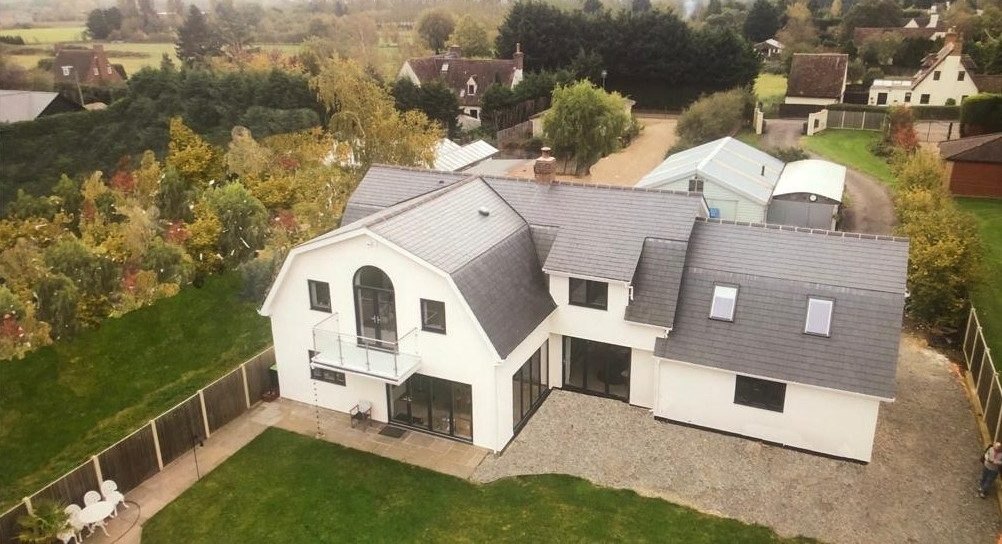 Contemporary gabled new-build home in charred timber and handmade brick in the British countryside