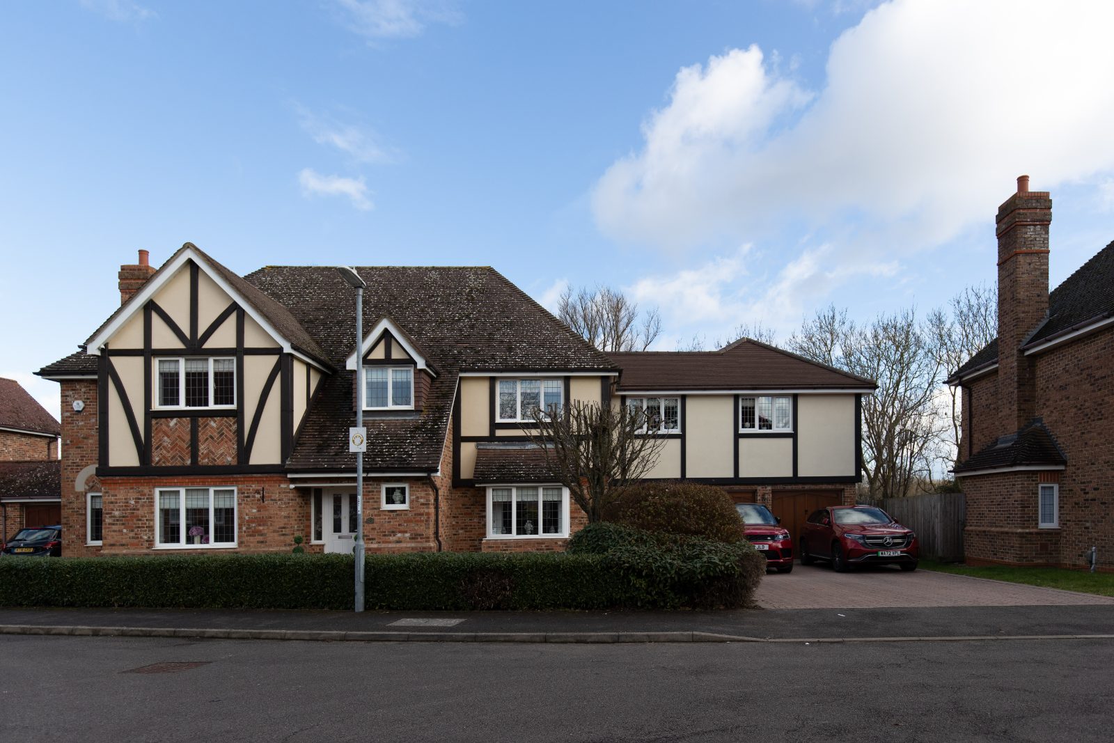 External view of a handsome two-storey home, showing the new first-floor extension built seamlessly above the integrated garage.