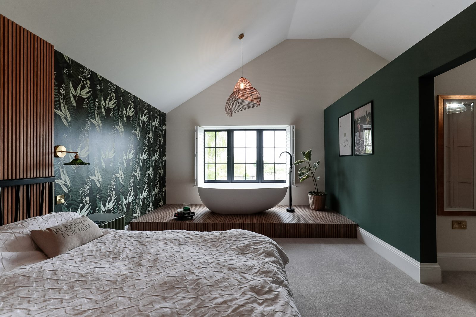 Loft conversion bedroom with exposed white-painted rafters and Velux rooflights